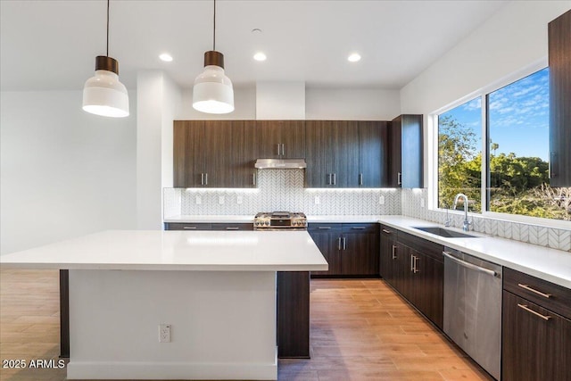 1717 E Morten Ave Unit 2, Phoenix, AZ 85020 - kitchen featuring appliances with stainless steel finishes, sink, a center island, hanging light fixtures, and dark brown cabinetry