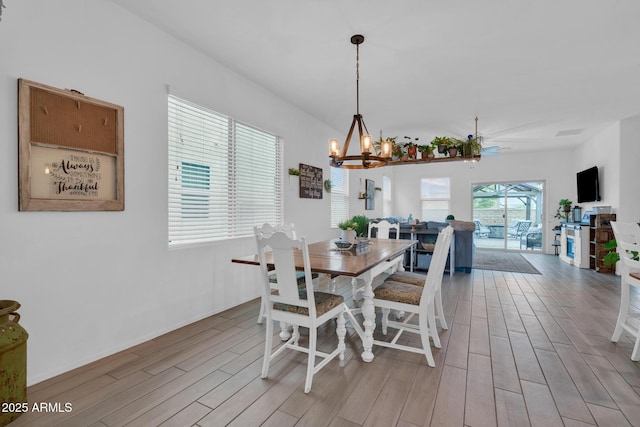 6754 E Via Rancho Rosario, Tucson, AZ 85756 - dining room with light wood-style floors, a chandelier, and baseboards