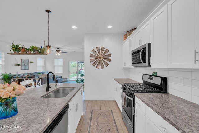 6754 E Via Rancho Rosario, Tucson, AZ 85756 - kitchen with stainless steel appliances, a sink, decorative backsplash, open floor plan, and recessed lighting