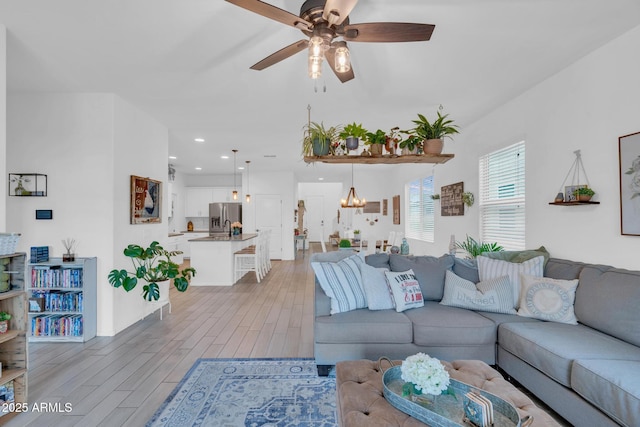 6754 E Via Rancho Rosario, Tucson, AZ 85756 - living room featuring ceiling fan, light wood-style floors, a chandelier, and recessed lighting