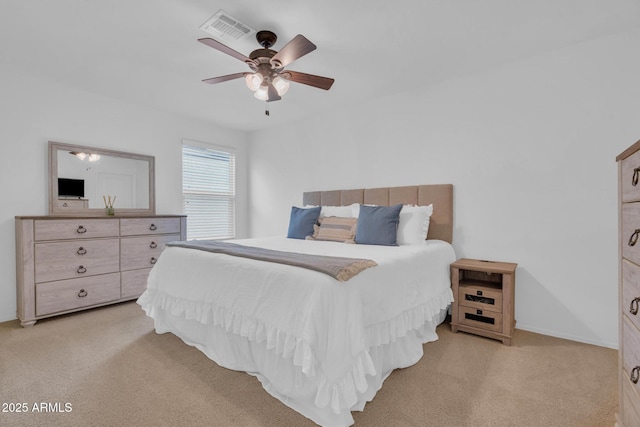 6754 E Via Rancho Rosario, Tucson, AZ 85756 - bedroom with light colored carpet and a ceiling fan