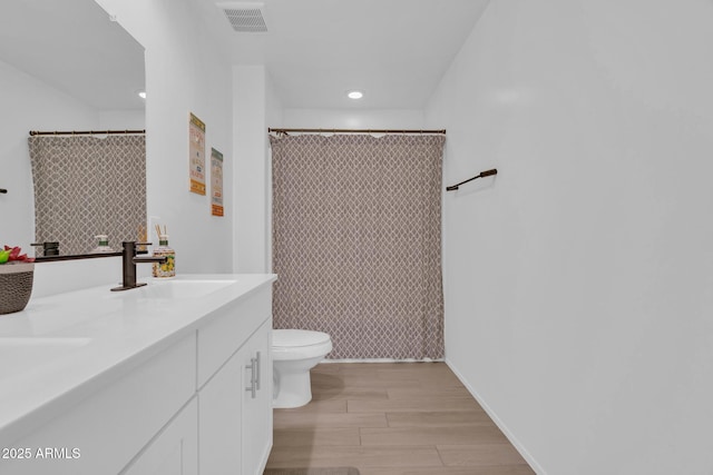 6754 E Via Rancho Rosario, Tucson, AZ 85756 - bathroom with toilet, wood finished floors, double vanity, recessed lighting, and a shower with shower curtain