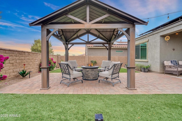 6754 E Via Rancho Rosario, Tucson, AZ 85756 - patio terrace at dusk featuring a gazebo and an outdoor fire pit