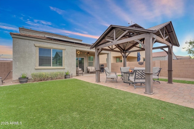 6754 E Via Rancho Rosario, Tucson, AZ 85756 - back of property at dusk featuring stucco siding, a patio area, and a gazebo