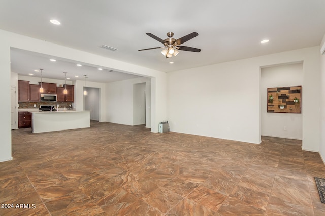 unfurnished living room featuring ceiling fan