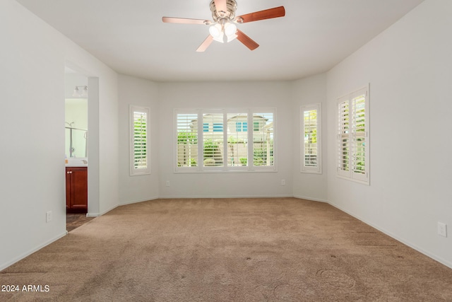 carpeted empty room featuring ceiling fan