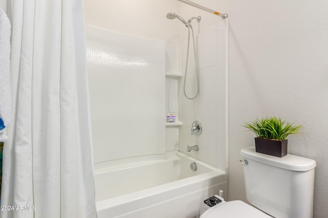 bathroom featuring toilet and shower / bath combination with curtain