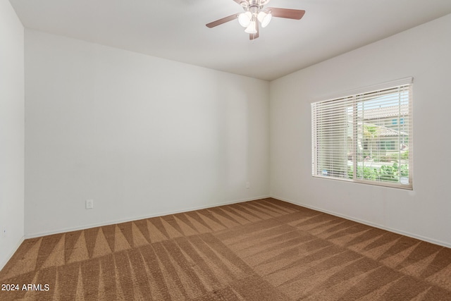 empty room with ceiling fan and carpet floors