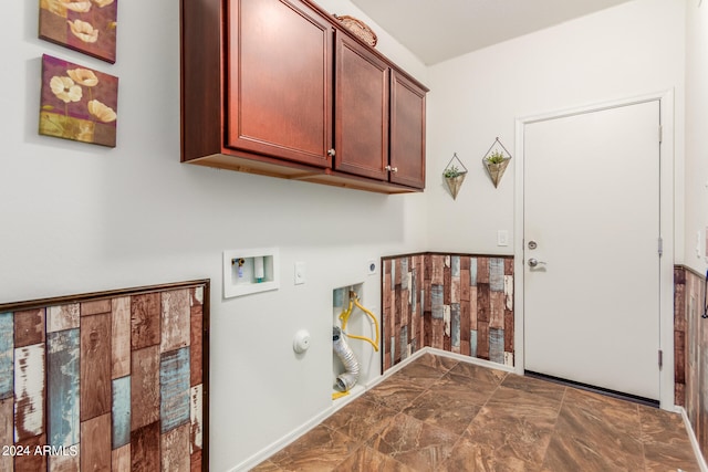 clothes washing area featuring gas dryer hookup, washer hookup, cabinets, and hookup for an electric dryer