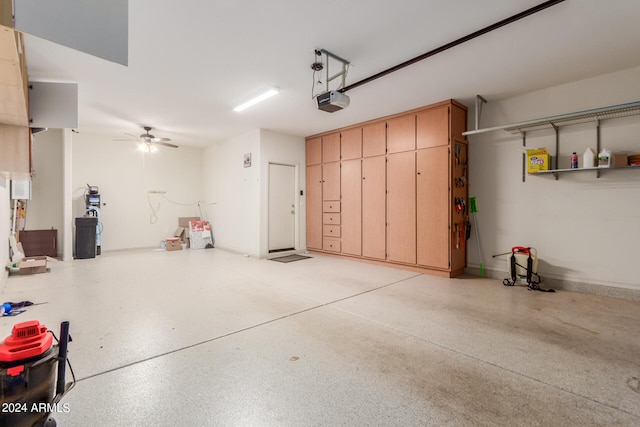 garage with ceiling fan and a garage door opener