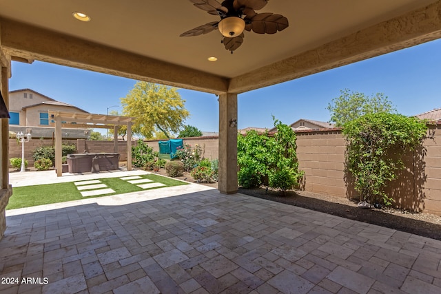 view of patio featuring ceiling fan and a hot tub