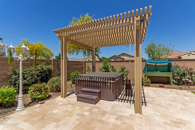 view of patio / terrace with a jacuzzi and a pergola