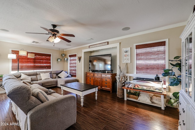 living room featuring dark wood-type flooring, ceiling fan, and crown molding