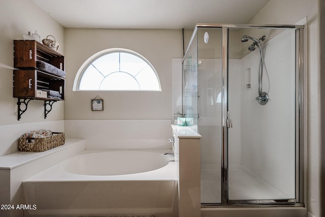 bathroom featuring separate shower and tub