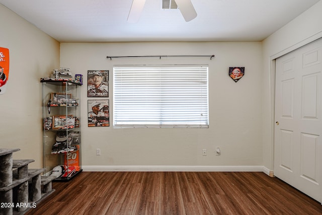 bedroom featuring dark wood-type flooring, ceiling fan, and a closet