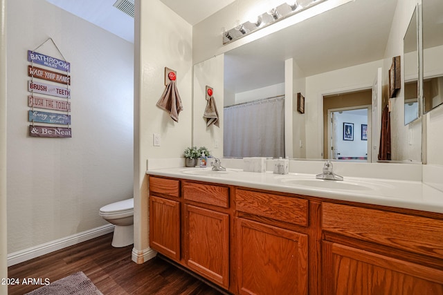 bathroom with vanity, hardwood / wood-style flooring, and toilet