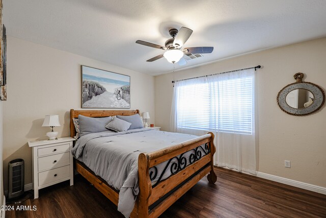 bedroom with dark hardwood / wood-style flooring and ceiling fan