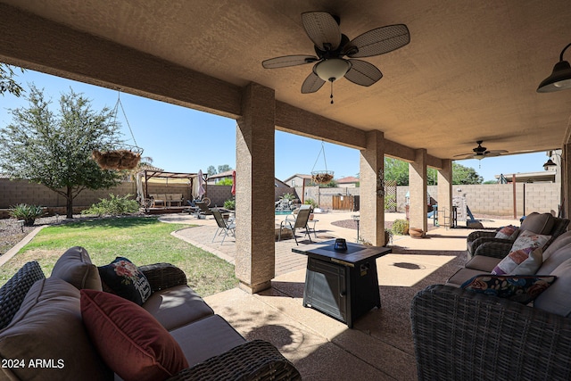 view of patio with ceiling fan and an outdoor living space