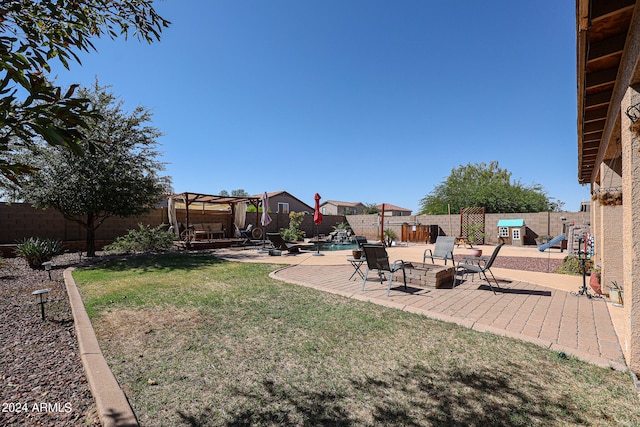 view of yard featuring a fenced in pool, a patio, and a pergola