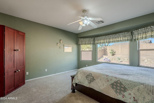 bedroom with ceiling fan and light colored carpet