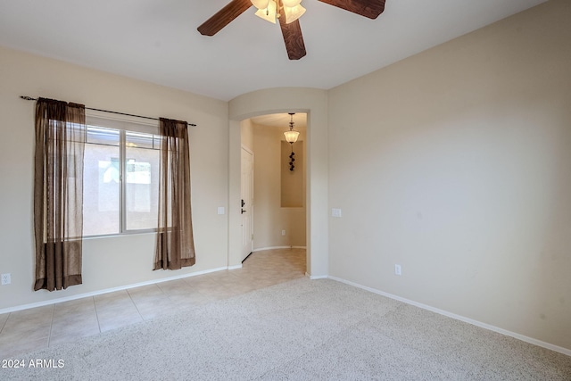 unfurnished room with ceiling fan and light colored carpet