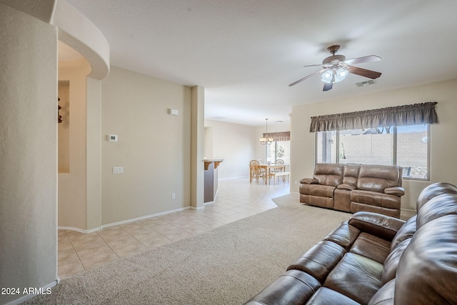 carpeted living room featuring plenty of natural light and ceiling fan