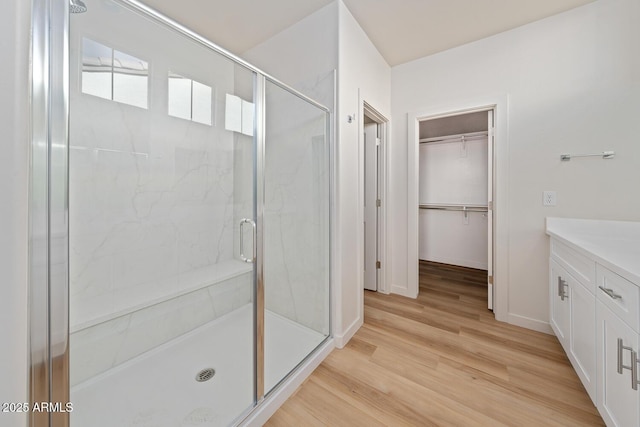 bathroom featuring hardwood / wood-style flooring, an enclosed shower, and vanity