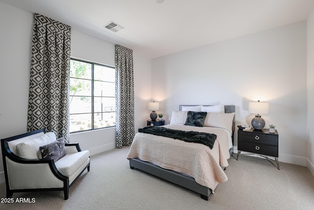 bedroom with multiple windows and light carpet