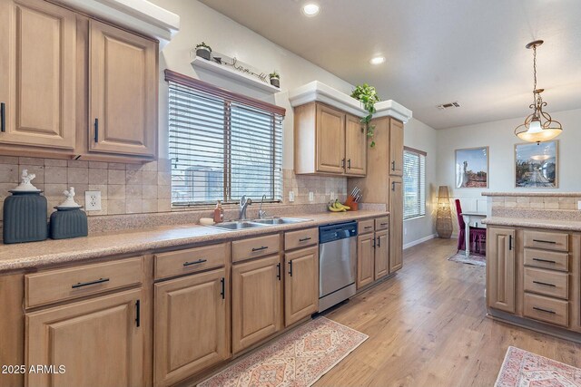 kitchen with visible vents, light wood-style flooring, plenty of natural light, a sink, and stainless steel dishwasher