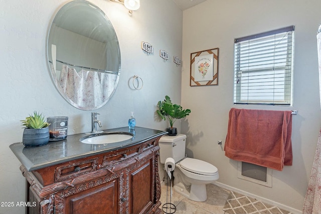 bathroom with vanity, toilet, and tile patterned flooring