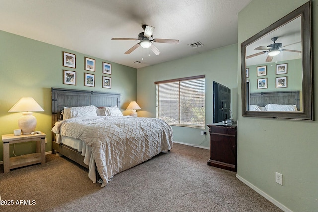 bedroom with visible vents, baseboards, carpet floors, and ceiling fan