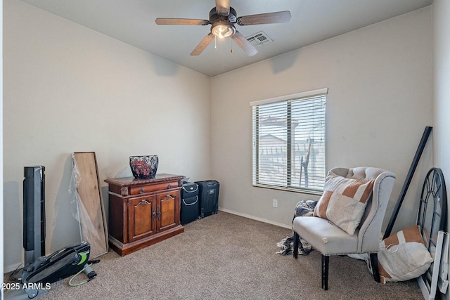 sitting room featuring baseboards, visible vents, carpet floors, and ceiling fan