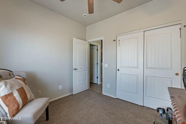 living area with carpet, baseboards, and ceiling fan