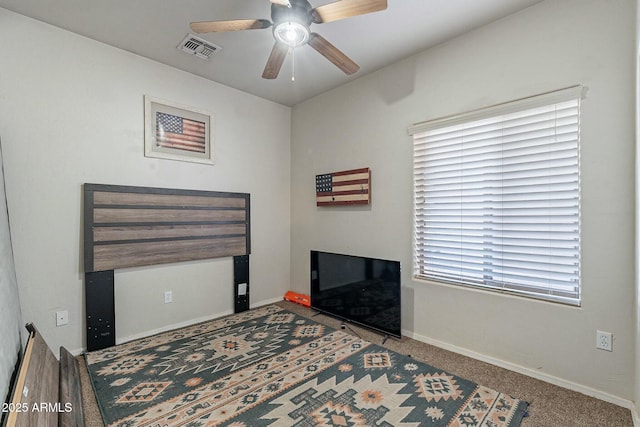 carpeted bedroom featuring visible vents, baseboards, and a ceiling fan