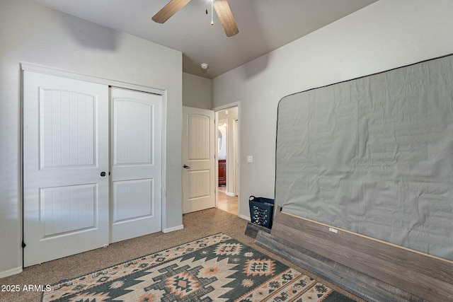 bedroom with a closet, ceiling fan, baseboards, and carpet floors