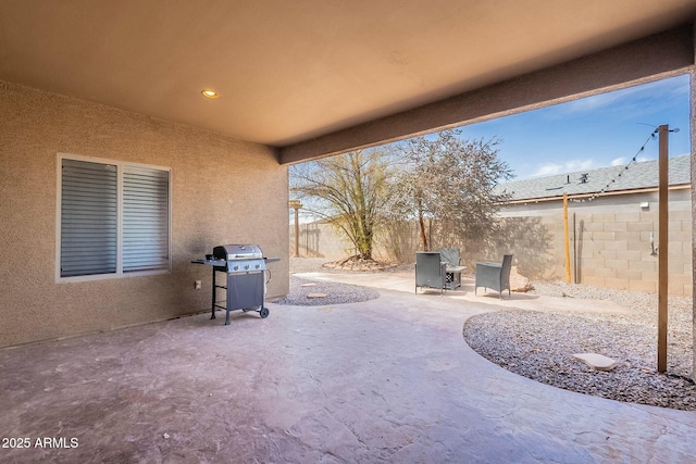 view of patio / terrace with grilling area and a fenced backyard