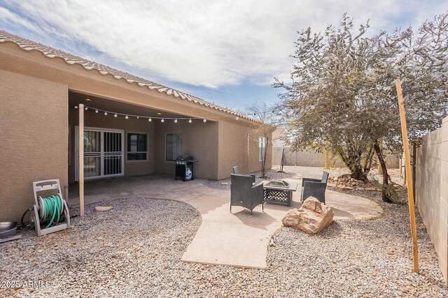 view of patio / terrace with area for grilling, a fire pit, and a fenced backyard