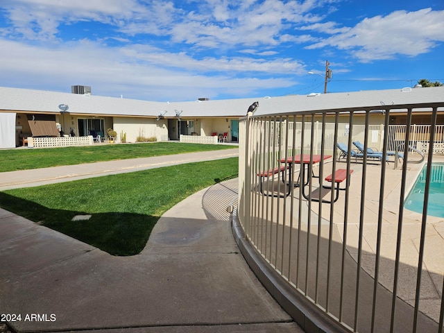 exterior space with a patio, a pool, and a lawn