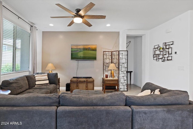 living room featuring hardwood / wood-style floors and ceiling fan