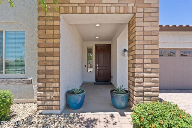 doorway to property with a garage