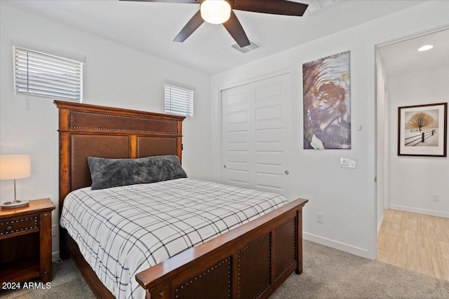 carpeted bedroom featuring a closet and ceiling fan