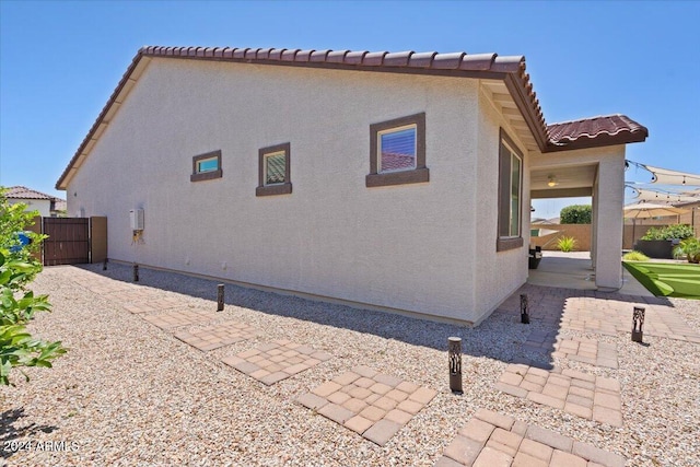 view of side of property with a patio