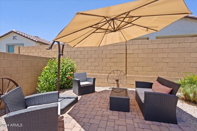 view of patio / terrace with an outdoor living space with a fire pit