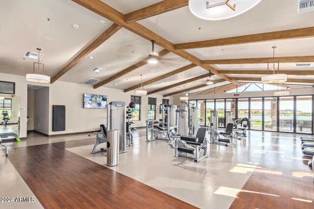 exercise room featuring light wood-type flooring and lofted ceiling