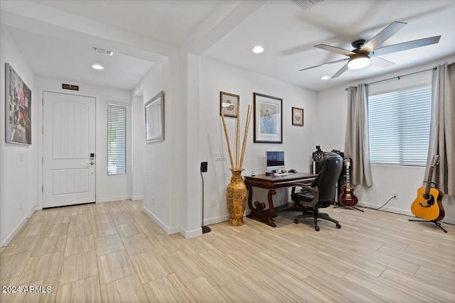 home office featuring light hardwood / wood-style flooring and ceiling fan