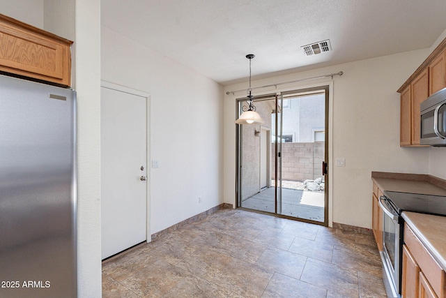 1244 S Tacoma, Mesa, AZ 85209 - kitchen featuring stainless steel appliances, brown cabinetry, hanging light fixtures, and baseboards