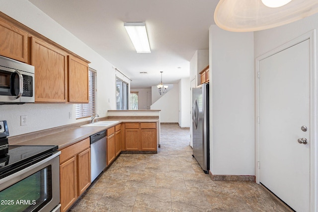 1244 S Tacoma, Mesa, AZ 85209 - kitchen with stainless steel appliances, a peninsula, a chandelier, a sink, and stone finish flooring