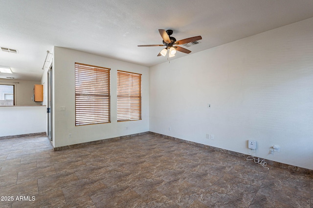 1244 S Tacoma, Mesa, AZ 85209 - spare room featuring ceiling fan, baseboards, and stone finish floors