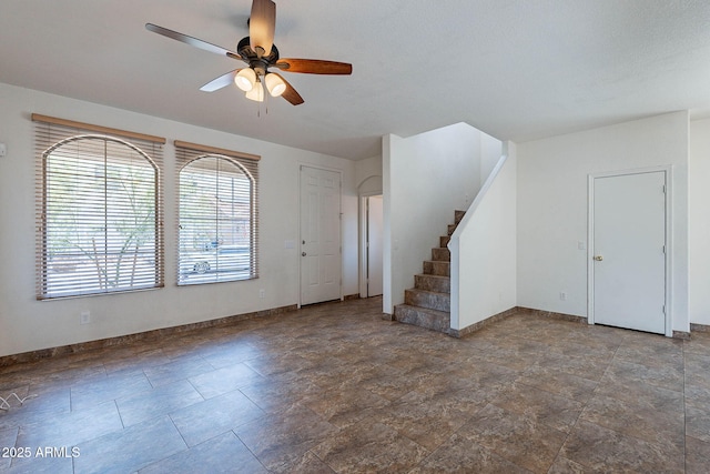 1244 S Tacoma, Mesa, AZ 85209 - unfurnished living room with ceiling fan, baseboards, stairs, and stone finish flooring