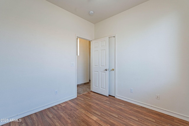 1244 S Tacoma, Mesa, AZ 85209 - unfurnished room featuring wood finished floors, baseboards, and a smoke detector